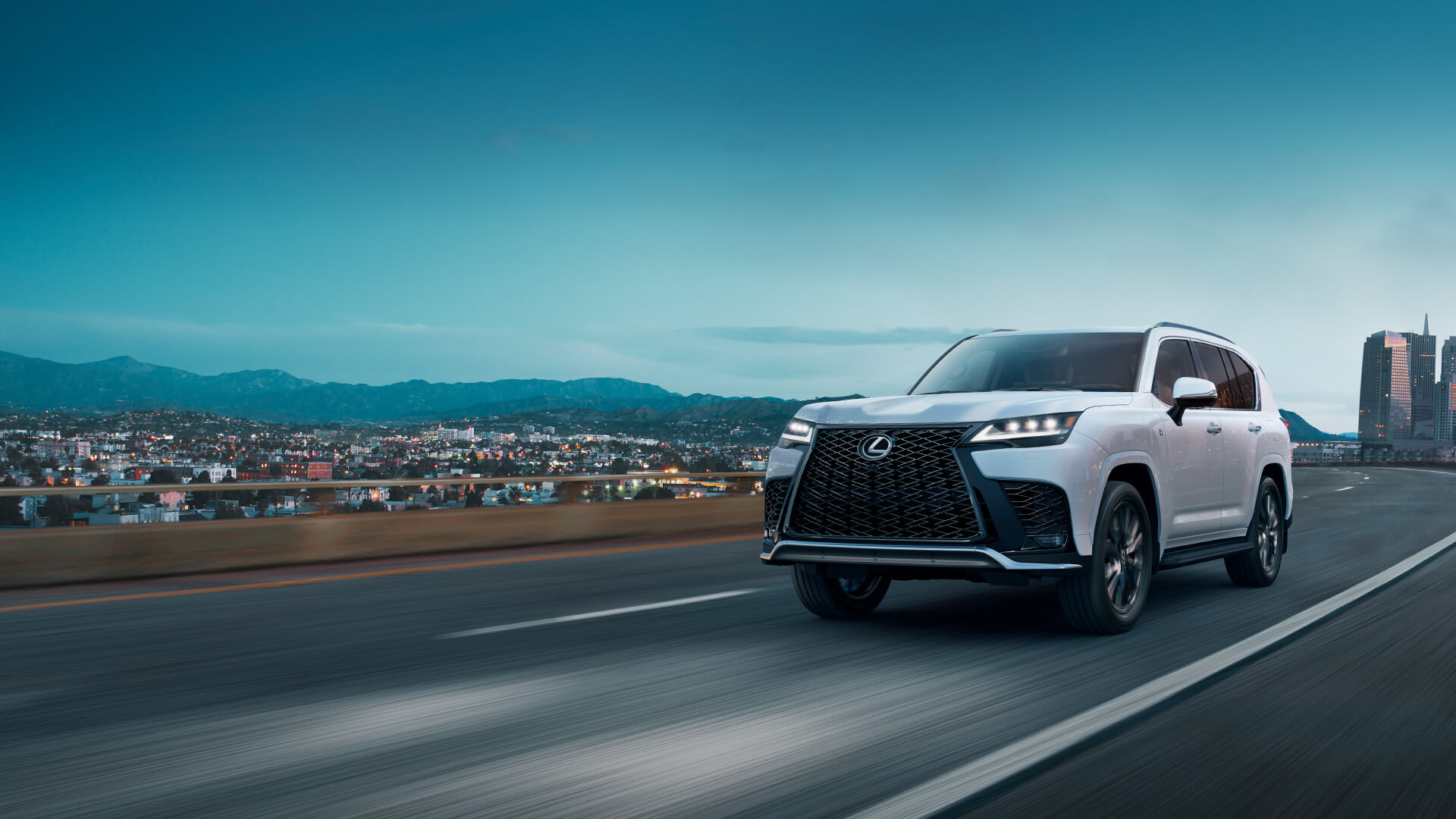 White Lexus LX being driven on the road.