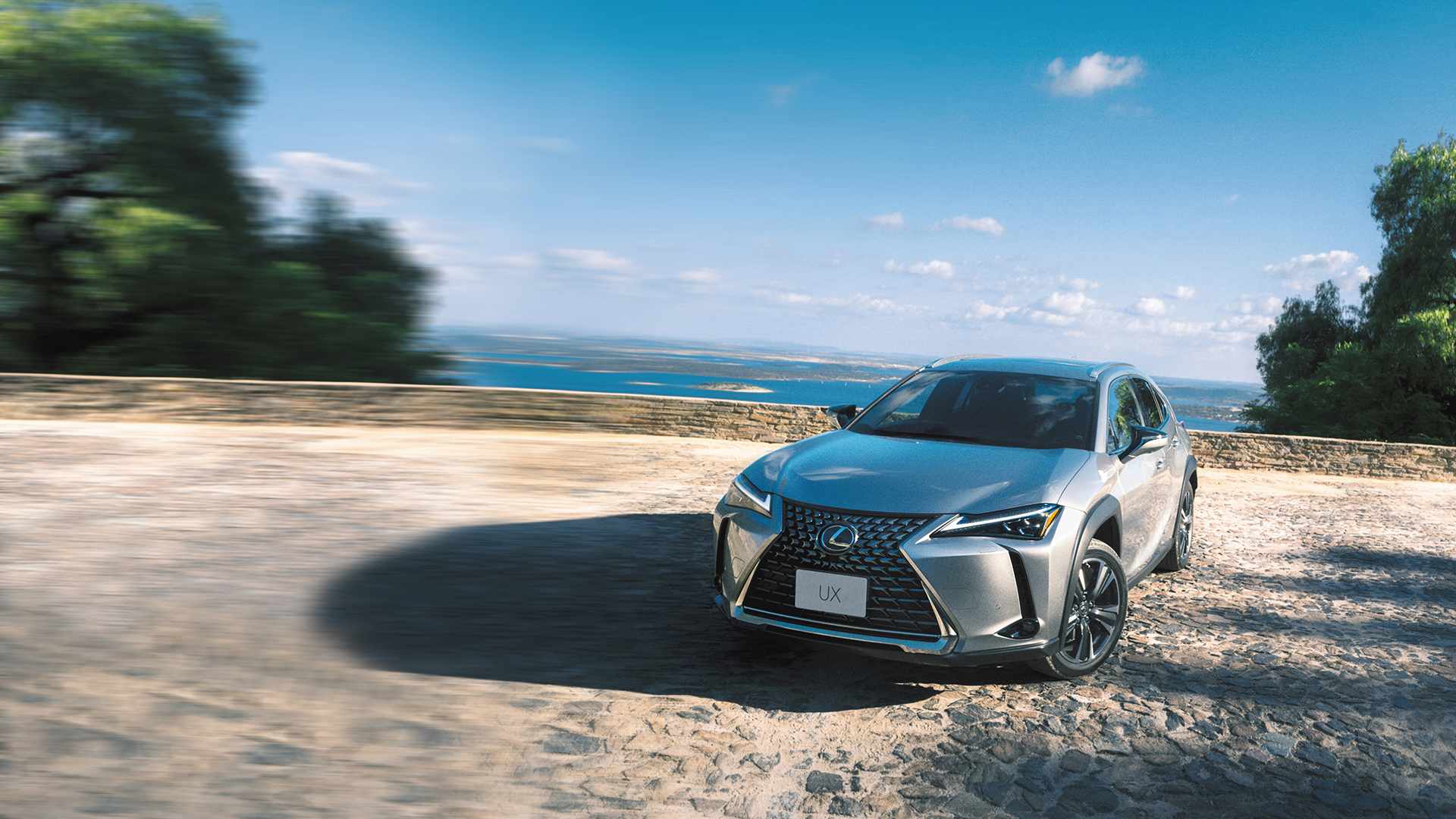 White Lexus UX driving through the city